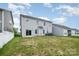 Large backyard with green grass, an installed trampoline, and sliding glass door entry to the house at 145 Yellow Birch Loop, Mooresville, NC 28117
