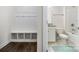 Neat bathroom with a shower and bathtub combo, as well as a mudroom bench to the left at 145 Yellow Birch Loop, Mooresville, NC 28117