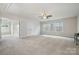 Large bedroom bathed in light, with neutral carpeting and a ceiling fan for added comfort at 145 Yellow Birch Loop, Mooresville, NC 28117