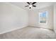 Well-lit bedroom provides a clean space with plush carpet and ample natural light from a window at 145 Yellow Birch Loop, Mooresville, NC 28117