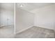 Clean, carpeted bedroom space with a large window and access to a closet at 145 Yellow Birch Loop, Mooresville, NC 28117