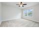 Bedroom with a ceiling fan and a double window overlooking green trees at 145 Yellow Birch Loop, Mooresville, NC 28117