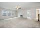 Spacious bonus room with a ceiling fan, neutral carpeting, and natural light from multiple windows at 145 Yellow Birch Loop, Mooresville, NC 28117