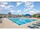 Large community pool with lounge chairs and umbrellas on a sunny day at 145 Yellow Birch Loop, Mooresville, NC 28117