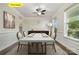 Dining room features modern table set, wood floors, and natural light from the bright windows at 145 Yellow Birch Loop, Mooresville, NC 28117