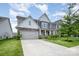Charming two-story home with manicured lawn, stone accents, gray siding and a spacious driveway at 145 Yellow Birch Loop, Mooresville, NC 28117