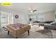 Spacious game room with a sectional sofa, dart board, and foosball table for Gathering and friends at 145 Yellow Birch Loop, Mooresville, NC 28117