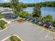 View of community kayak storage area at the lake, with marked parking spaces and landscaping at 145 Yellow Birch Loop, Mooresville, NC 28117