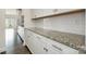 Bright kitchen with granite countertop, white cabinets, and stainless steel hardware at 145 Yellow Birch Loop, Mooresville, NC 28117