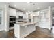 Modern kitchen with granite island, white cabinets, stainless appliances, and hardwood floors at 145 Yellow Birch Loop, Mooresville, NC 28117