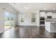 Open kitchen and dining area with stainless steel appliances, granite counters, and sliding glass doors at 145 Yellow Birch Loop, Mooresville, NC 28117