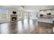 Inviting living room features a stone fireplace, abundant natural light, and beautiful dark wood floors at 145 Yellow Birch Loop, Mooresville, NC 28117