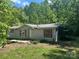 Cozy home with red shutters presents a traditional façade in a wooded, secluded location at 156 Hurst Dr, Statesville, NC 28677