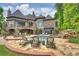 Backyard with stone patio, lounge chairs, swimming pool and rock waterfall that create a luxurious outdoor retreat at 16909 Jetton Rd, Cornelius, NC 28031