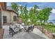 Backyard patio on a luxury home overlooking a lake surrounded by trees at 16909 Jetton Rd, Cornelius, NC 28031