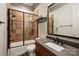 Bathroom features a tub, shower, dark wood vanity, and dark framed mirror at 16909 Jetton Rd, Cornelius, NC 28031