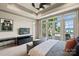 Bright bedroom features patio access, desk, and a trey ceiling at 16909 Jetton Rd, Cornelius, NC 28031