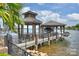 Picturesque boat dock with covered seating area and boat lift, offering direct lake access at 16909 Jetton Rd, Cornelius, NC 28031