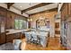 Elegant kitchen featuring a brick accent wall, large island, and open layout to the dining area at 16909 Jetton Rd, Cornelius, NC 28031