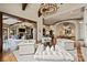 Open-concept living area with hardwood floors, stone fireplace, and comfortable seating at 16909 Jetton Rd, Cornelius, NC 28031