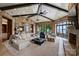 Spacious living room features exposed beams, a stone fireplace, and scenic lake views at 16909 Jetton Rd, Cornelius, NC 28031