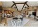Open living room with stone walls, a decorative ceiling, and seamless access to adjacent rooms at 16909 Jetton Rd, Cornelius, NC 28031