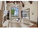 Bright living room with large windows offering panoramic views of the lake and manicured grounds at 16909 Jetton Rd, Cornelius, NC 28031