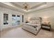 Well-lit main bedroom boasts a trey ceiling, chandelier, and patio access at 16909 Jetton Rd, Cornelius, NC 28031