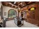 Stately home office with rich wood paneling, custom built-ins and large window with a view of the manicured grounds at 16909 Jetton Rd, Cornelius, NC 28031