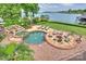 Entertainer's dream backyard with pool, hot tub, stone waterfall feature, and outdoor fireplace at 16909 Jetton Rd, Cornelius, NC 28031