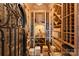 Charming wine cellar featuring custom wood racking, brick ceiling, and wrought iron gate at 16909 Jetton Rd, Cornelius, NC 28031