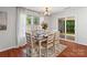Dining room with 6 chairs, table setting, area rug, and sliding glass doors to the back patio at 1961 Leesburg Dr, Clover, SC 29710