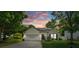 Charming single-story home with white siding, manicured lawn, and solar panels at sunset at 1961 Leesburg Dr, Clover, SC 29710