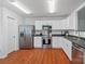 Updated kitchen with stainless steel appliances, white cabinets, and wood floors at 1961 Leesburg Dr, Clover, SC 29710