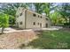 Large backyard showcasing a concrete patio, greenery and mature trees, ideal for outdoor gatherings at 218 Kingsway Cir, Charlotte, NC 28214
