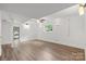 Finished basement showcasing new floor and lights, with walkout access at 218 Kingsway Cir, Charlotte, NC 28214