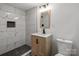 Stylish bathroom with new vanity, mirror, and a modern shower featuring black and white accent tiling at 218 Kingsway Cir, Charlotte, NC 28214