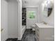 Bright bathroom with modern black and white tile and updated vanity at 218 Kingsway Cir, Charlotte, NC 28214