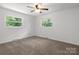 Bright bedroom with two windows, ceiling fan and neutral carpet at 218 Kingsway Cir, Charlotte, NC 28214