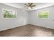 Bedroom featuring new flooring and bright natural light through two windows at 218 Kingsway Cir, Charlotte, NC 28214