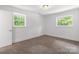 Bedroom with two windows for natural light and neutral carpet at 218 Kingsway Cir, Charlotte, NC 28214