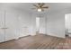Bedroom featuring wood-look floors, white walls, ceiling fan, and closet at 218 Kingsway Cir, Charlotte, NC 28214