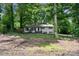 Charming home with freshly painted white brick, a dark roof and well-maintained landscaping at 218 Kingsway Cir, Charlotte, NC 28214