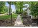Exterior of the home featuring a well-maintained yard and a walkway leading to the entrance at 218 Kingsway Cir, Charlotte, NC 28214