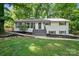 Charming home featuring a landscaped front yard, and a welcoming entrance with freshly painted stairs at 218 Kingsway Cir, Charlotte, NC 28214