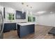 Modern kitchen featuring navy cabinets, stainless steel appliances, a center island, and unique pendant lighting at 218 Kingsway Cir, Charlotte, NC 28214