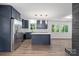 Well-lit kitchen featuring stainless steel appliances, an island with white countertop, and modern lighting fixtures at 218 Kingsway Cir, Charlotte, NC 28214