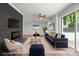 Elegant staged living room with a fireplace, blue furniture and views to the outside patio at 218 Kingsway Cir, Charlotte, NC 28214