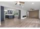 Open-concept space connecting the living room and kitchen with wood floors, modern fireplace, and natural light at 218 Kingsway Cir, Charlotte, NC 28214