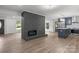 Open concept home featuring a fireplace and a kitchen with navy cabinets and stainless steel appliances at 218 Kingsway Cir, Charlotte, NC 28214